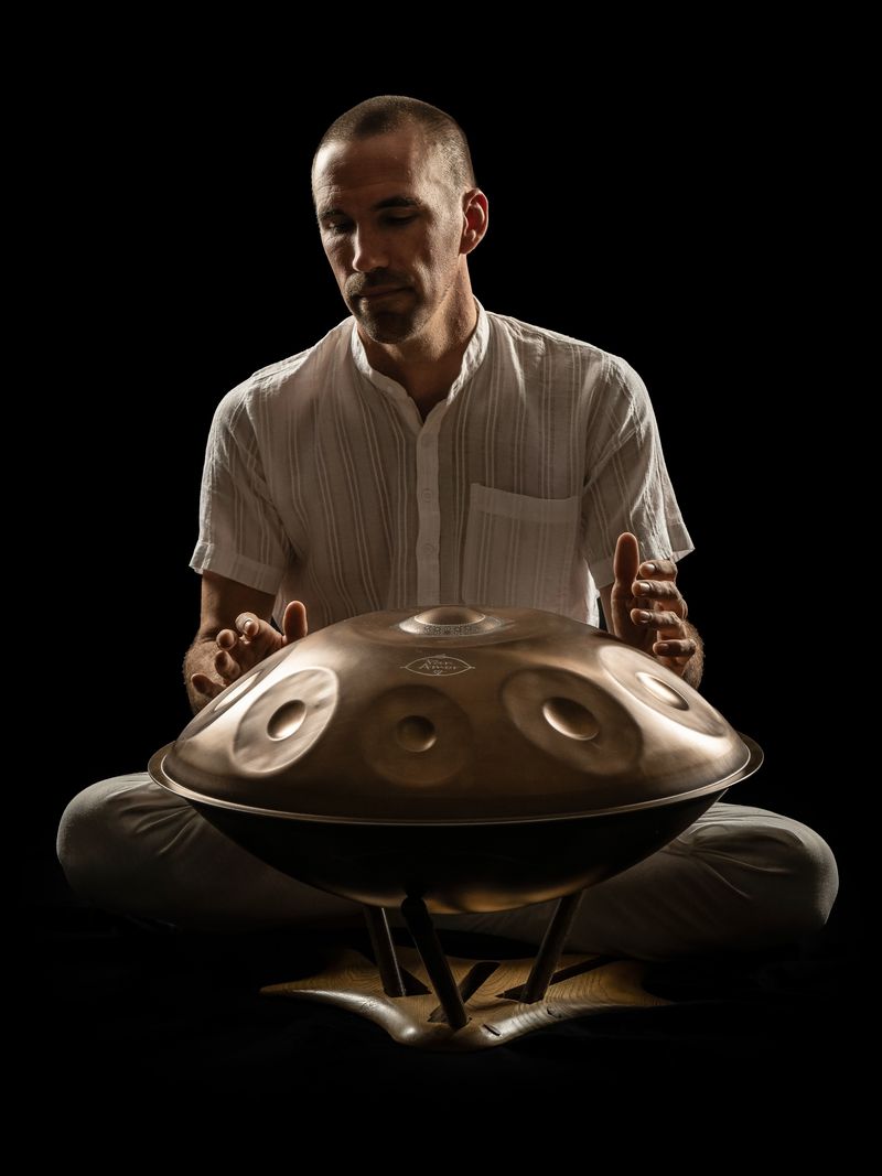 Handpan lit against black
